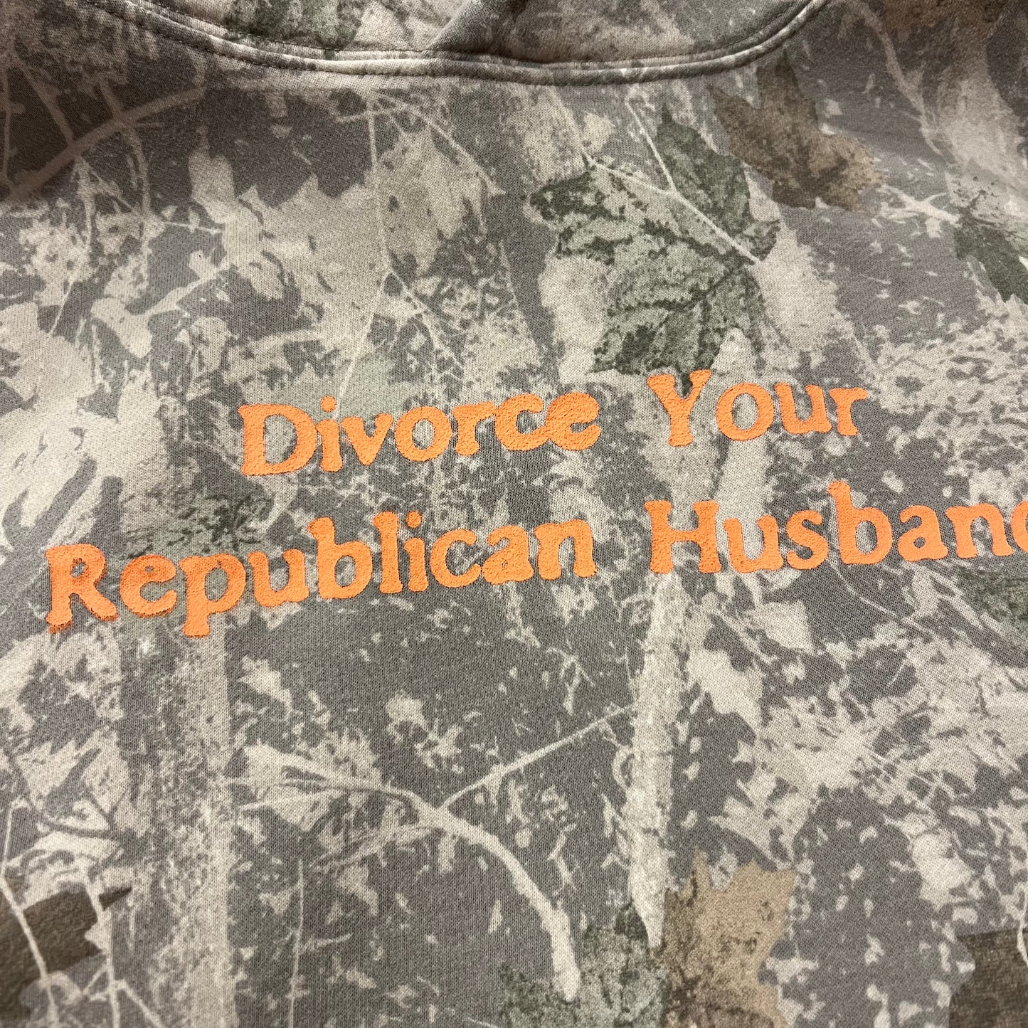 DIVORCE YOUR REPUBLICAN HUSBAND white camo hoodie with orange text (L)