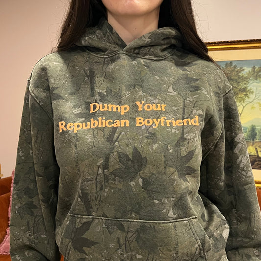 DUMP YOUR REPUBLICAN BOYFRIEND camo hoodie with orange text (S)