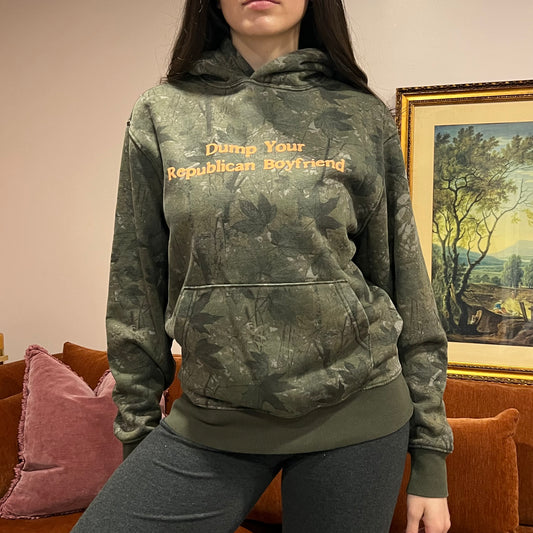 DUMP YOUR REPUBLICAN BOYFRIEND camo hoodie with orange text (S)